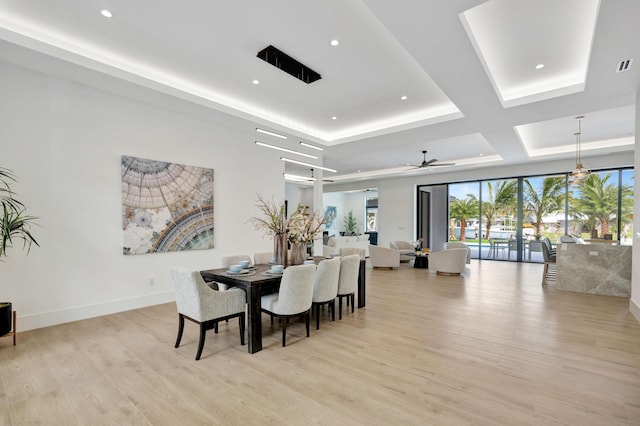 dining area with ceiling fan and light hardwood / wood-style floors