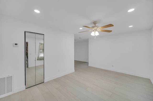 unfurnished room featuring ceiling fan and light hardwood / wood-style floors