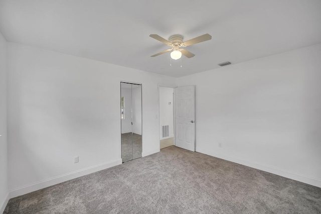 spare room featuring ceiling fan and carpet floors