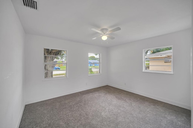 carpeted spare room with ceiling fan