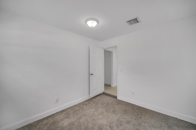 unfurnished room with light carpet