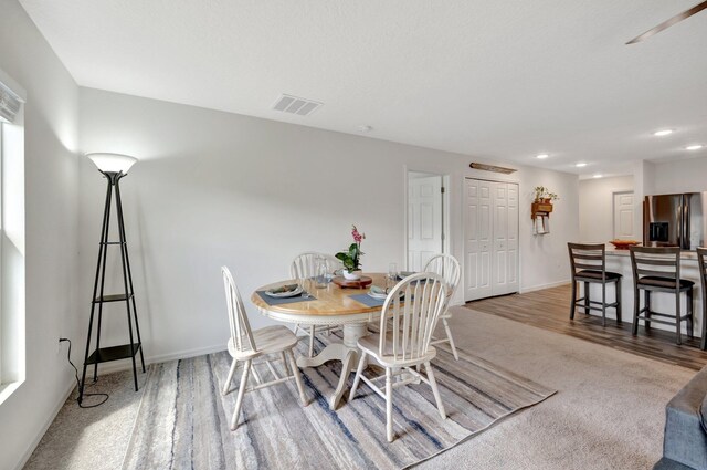 kitchen featuring white cabinets, dark hardwood / wood-style floors, a center island with sink, and stainless steel appliances