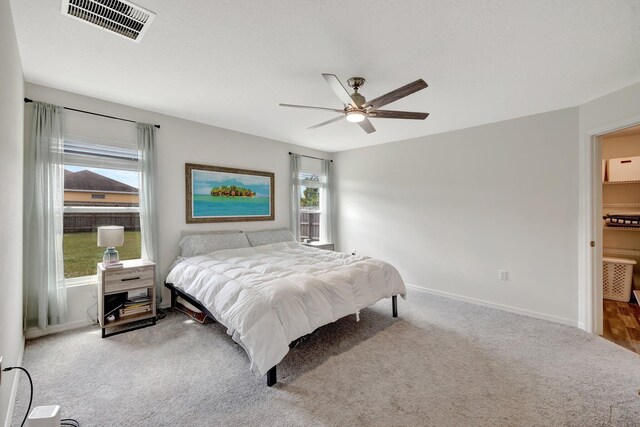 carpeted bedroom with a textured ceiling and a nursery area