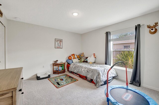 office featuring carpet, a textured ceiling, and a healthy amount of sunlight