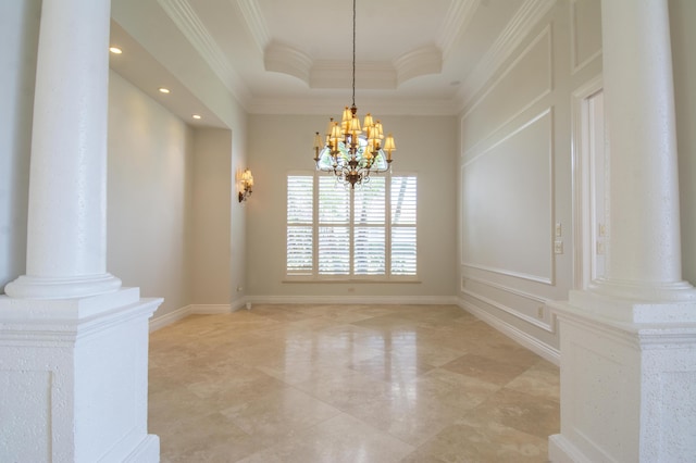 unfurnished dining area with decorative columns, crown molding, a tray ceiling, and an inviting chandelier