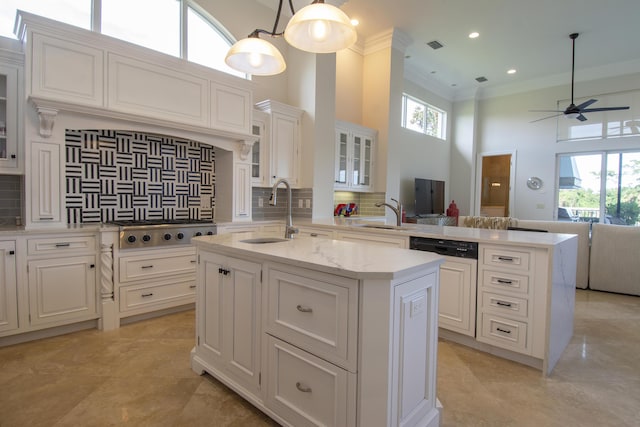 kitchen featuring pendant lighting, a center island with sink, paneled dishwasher, tasteful backsplash, and stainless steel gas cooktop