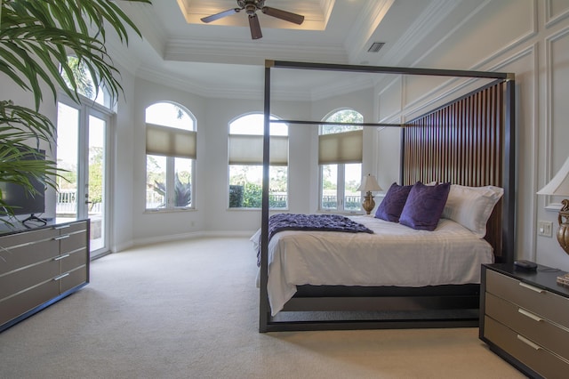 bedroom featuring light carpet, access to outside, a raised ceiling, ceiling fan, and ornamental molding