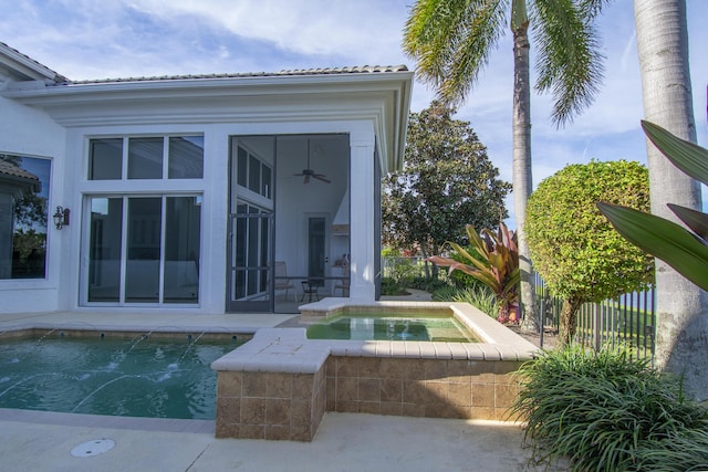 view of pool with ceiling fan and an in ground hot tub