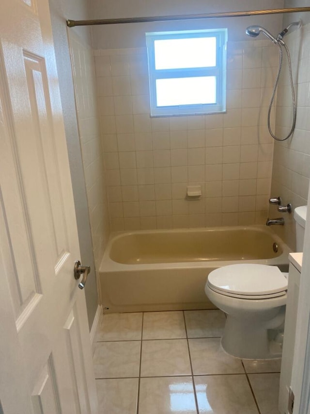 full bathroom featuring vanity, tiled shower / bath combo, tile patterned floors, and toilet