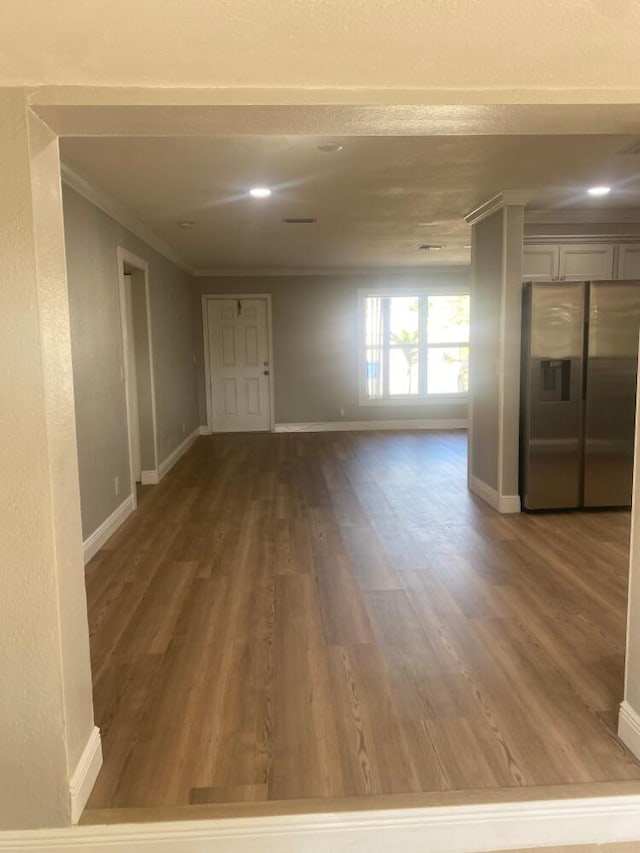 empty room featuring ornamental molding and hardwood / wood-style flooring