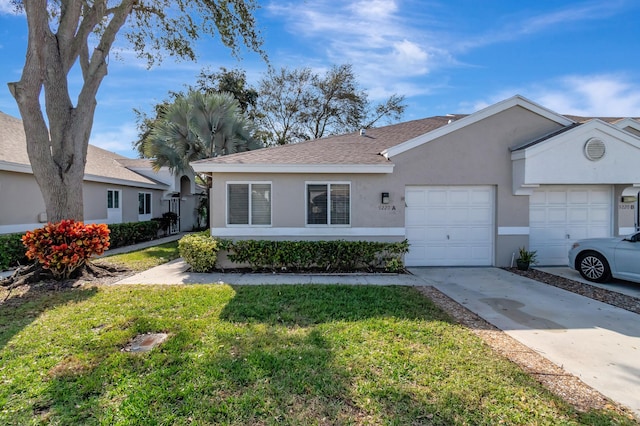 ranch-style home featuring a front lawn and a garage