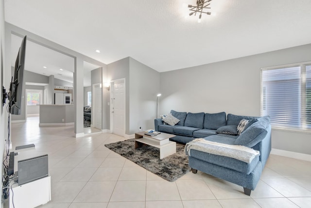 living room with light tile patterned floors and vaulted ceiling