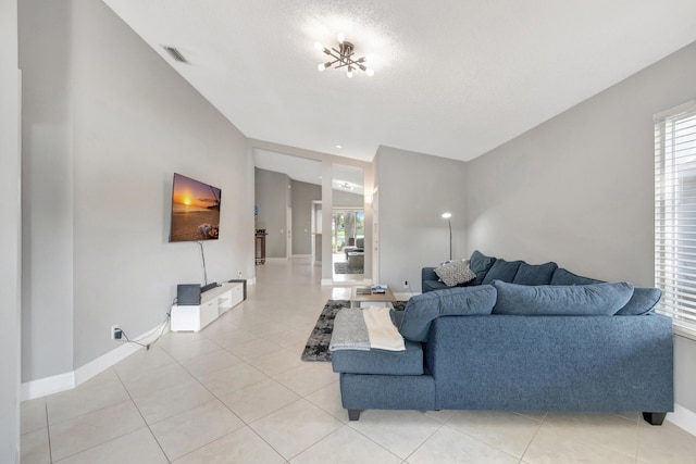 living room with light tile patterned floors and lofted ceiling