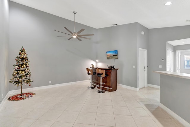 interior space featuring bar area, high vaulted ceiling, and ceiling fan