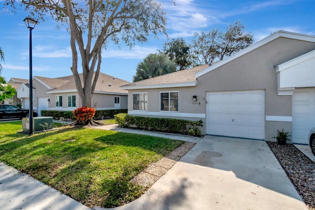 single story home featuring a front lawn and a garage