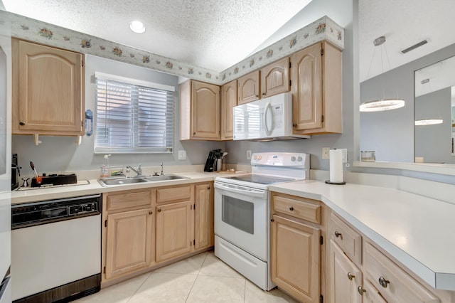 kitchen featuring light brown cabinets, white appliances, sink, light tile patterned floors, and a textured ceiling