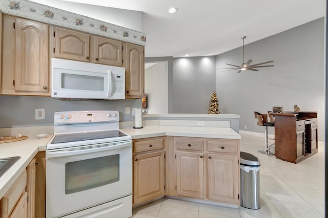 kitchen with ceiling fan, light brown cabinets, white appliances, and kitchen peninsula