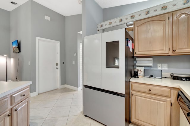 kitchen featuring dishwasher, light brown cabinets, refrigerator, and light tile patterned floors