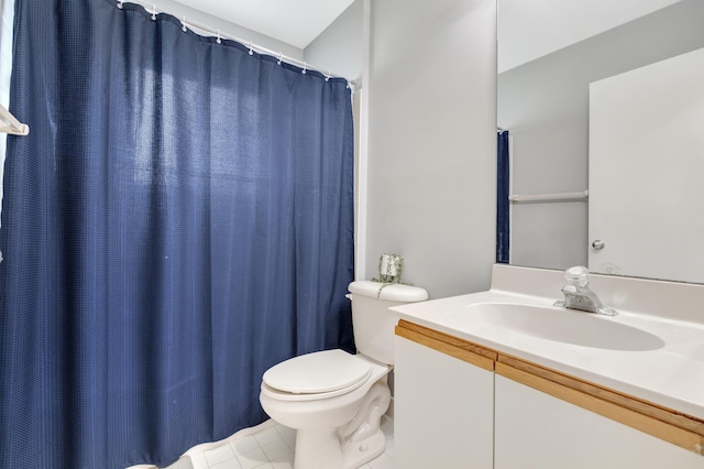 bathroom featuring tile patterned flooring, vanity, and toilet