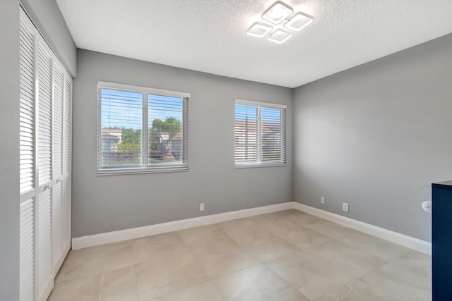 interior space with a closet and a textured ceiling