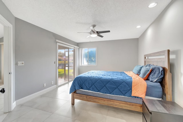 bedroom featuring access to exterior, a textured ceiling, and ceiling fan