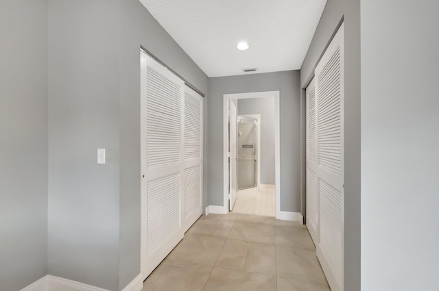 hallway featuring light tile patterned floors