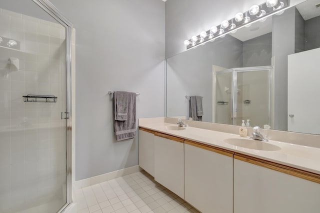 bathroom featuring tile patterned floors, vanity, and an enclosed shower