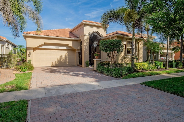 mediterranean / spanish home with a garage