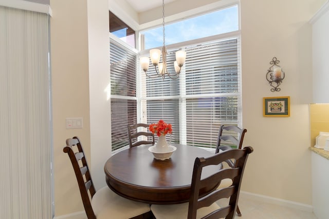 dining space with light tile patterned floors and a notable chandelier