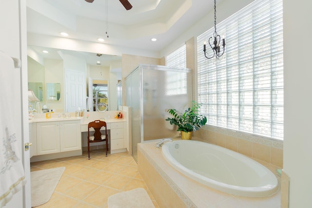 bathroom featuring vanity, ceiling fan with notable chandelier, a raised ceiling, independent shower and bath, and tile patterned flooring