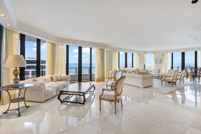 tiled living room featuring a water view