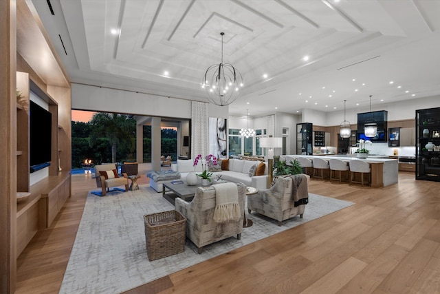 living room featuring light hardwood / wood-style flooring and an inviting chandelier