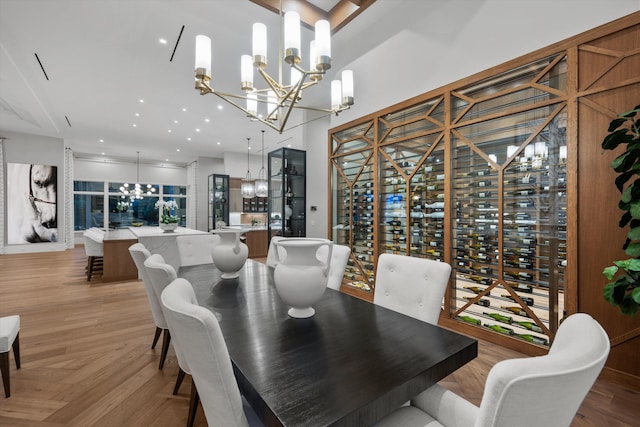 dining area featuring light parquet floors and a notable chandelier