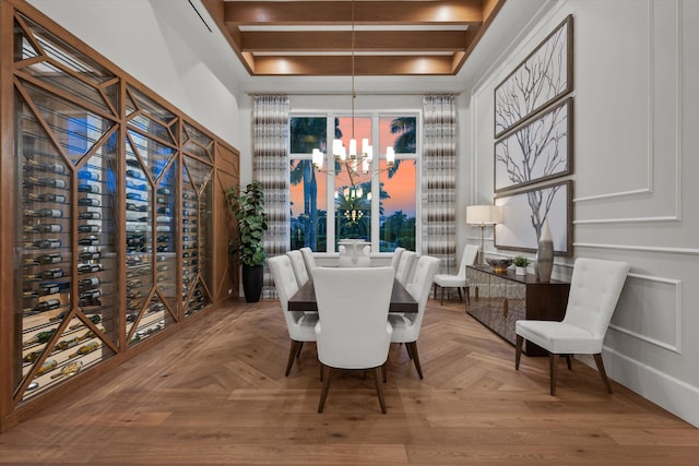 dining room with light parquet floors and a notable chandelier