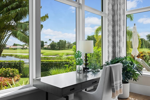 sunroom / solarium featuring a water view and a healthy amount of sunlight