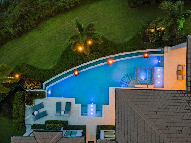 view of pool at night