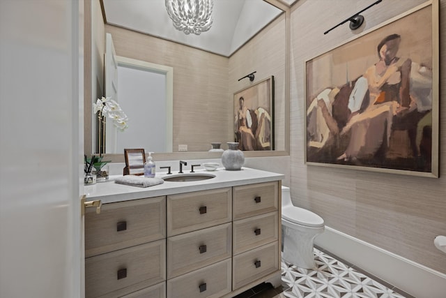 bathroom with vanity, toilet, and lofted ceiling