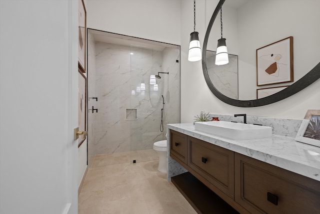 bathroom featuring vanity, toilet, and a shower with shower door