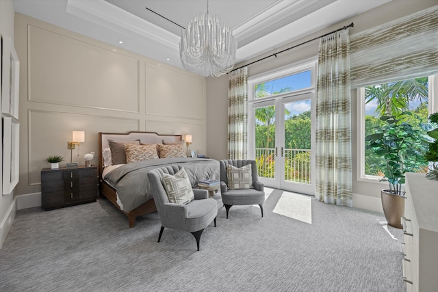 bedroom with access to exterior, light carpet, a raised ceiling, crown molding, and an inviting chandelier