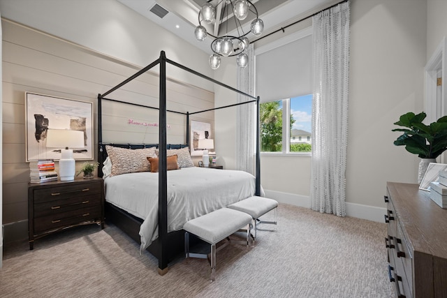 carpeted bedroom with an inviting chandelier