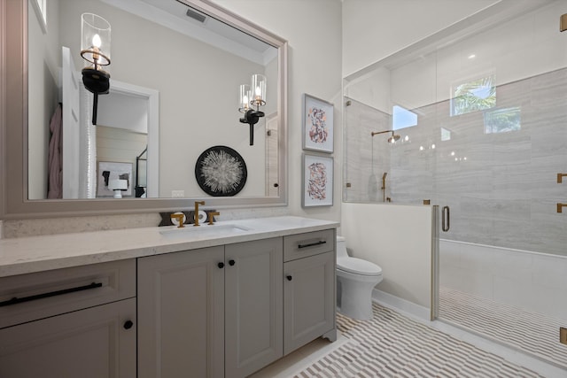 bathroom with tile patterned floors, vanity, an enclosed shower, and toilet