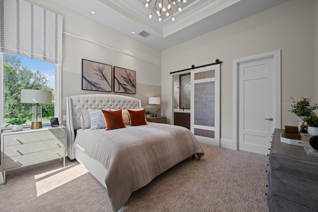 bedroom featuring ornamental molding, a tray ceiling, a barn door, an inviting chandelier, and carpet floors