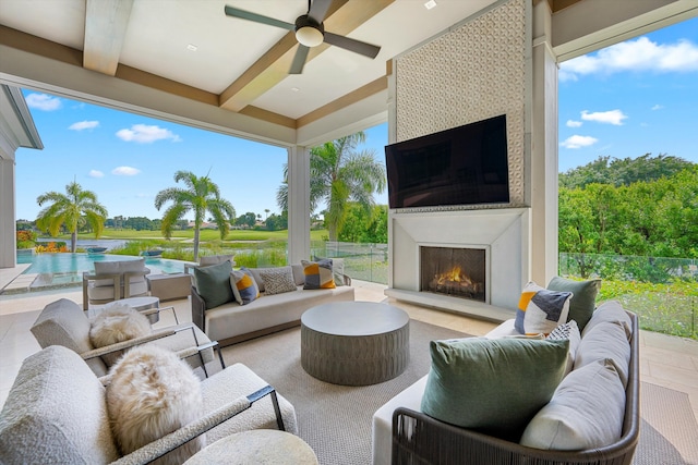 view of patio with an outdoor living space with a fireplace and ceiling fan