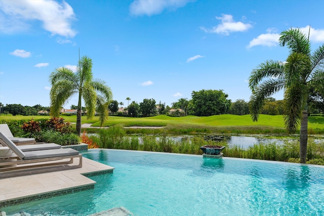 view of swimming pool with a water view