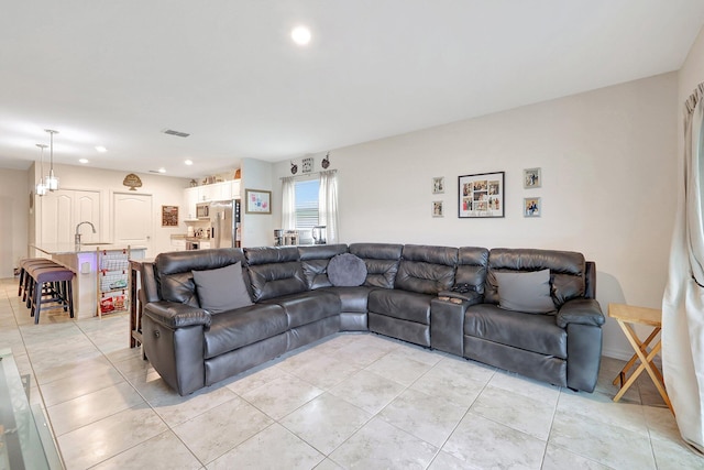 living room with light tile patterned floors and sink