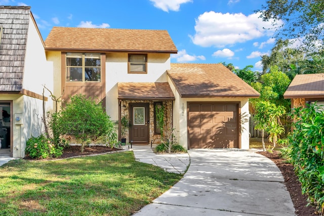 view of property featuring a front yard and a garage