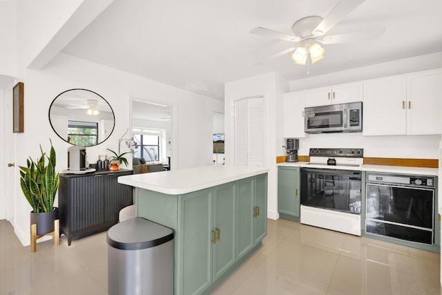 kitchen featuring white cabinetry, electric range, a center island, light tile patterned floors, and green cabinetry