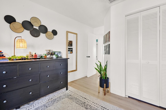 interior space with light hardwood / wood-style floors and a closet