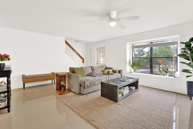 living room with ceiling fan and light tile patterned flooring