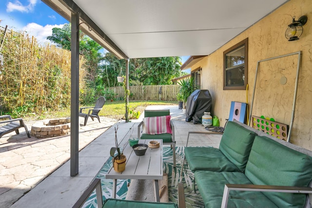 view of patio featuring grilling area and an outdoor living space with a fire pit